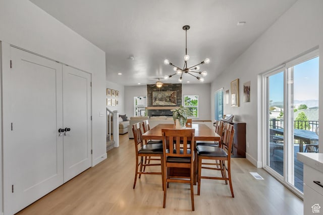 753 N Stallion Dr Unit 601, Spanish Fork, UT 84660 - dining space with light wood finished floors, a chandelier, recessed lighting, baseboards, and a large fireplace