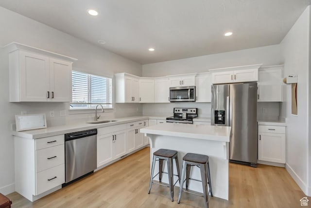 753 N Stallion Dr Unit 601, Spanish Fork, UT 84660 - kitchen with appliances with stainless steel finishes, a sink, white cabinetry, light wood-type flooring, and recessed lighting