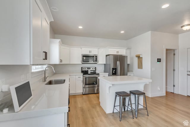 753 N Stallion Dr Unit 601, Spanish Fork, UT 84660 - kitchen featuring stainless steel appliances, a sink, a kitchen breakfast bar, light wood-type flooring, and recessed lighting