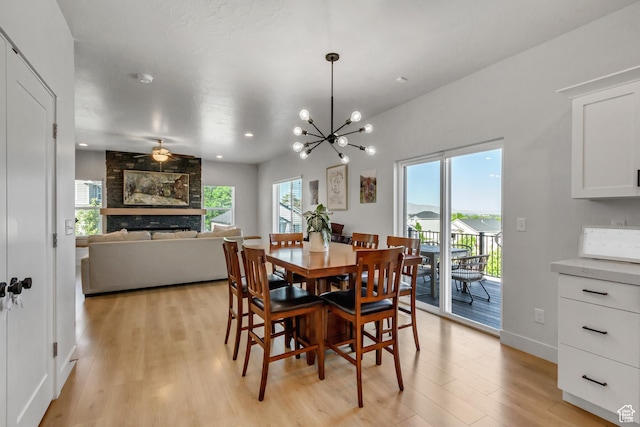 753 N Stallion Dr Unit 601, Spanish Fork, UT 84660 - dining area featuring light wood-type flooring, a fireplace, a chandelier, recessed lighting, and baseboards