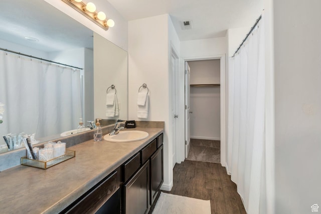 2987 S Willow Creek Dr, Saratoga Springs, UT 84045 - bathroom with wood finished floors, vanity, and baseboards
