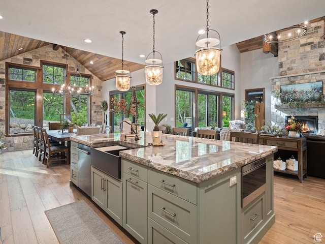 1156 N Valley View Dr, Eden, UT 84310 - kitchen with stainless steel appliances, high vaulted ceiling, open floor plan, a sink, and light stone counters
