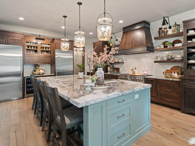 1156 N Valley View Dr, Eden, UT 84310 - kitchen with high quality appliances, custom range hood, open shelves, beverage cooler, and tasteful backsplash