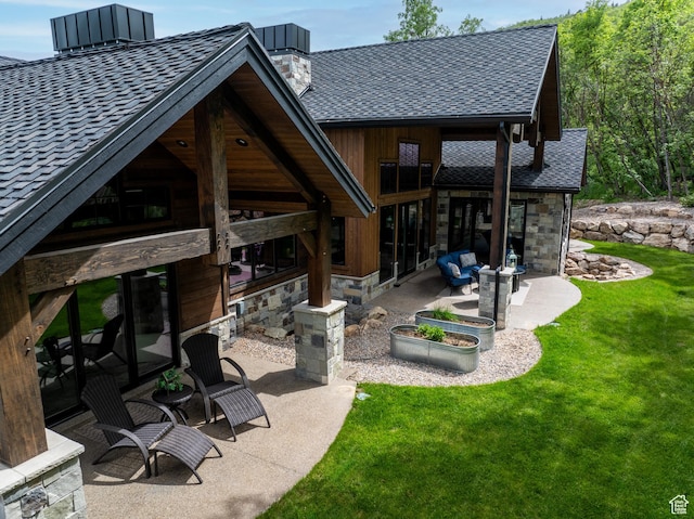 1156 N Valley View Dr, Eden, UT 84310 - back of property with a patio, a chimney, stone siding, a yard, and a shingled roof