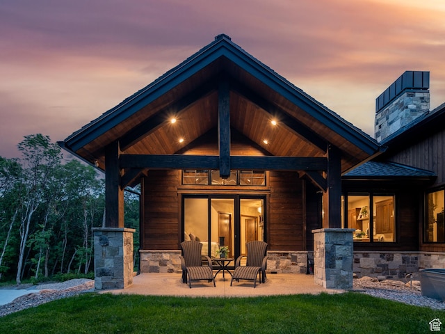 1156 N Valley View Dr, Eden, UT 84310 - rear view of house featuring a chimney, stone siding, a yard, and a patio