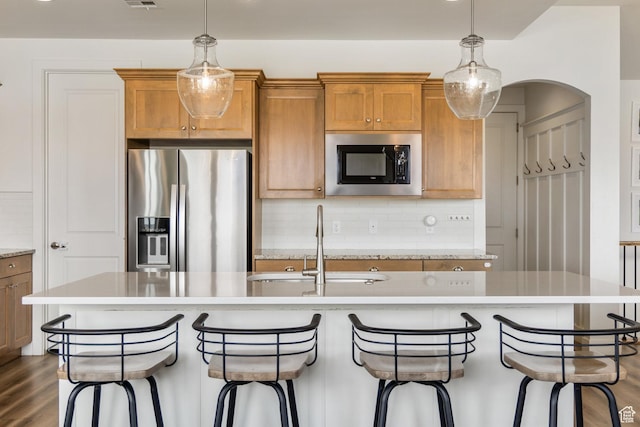 1432 Boys Pond Cir, Santa Clara, UT 84765 - kitchen featuring appliances with stainless steel finishes, brown cabinets, backsplash, and a sink