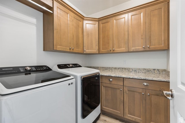 1432 Boys Pond Cir, Santa Clara, UT 84765 - laundry area featuring cabinet space, washer and clothes dryer, and light wood finished floors