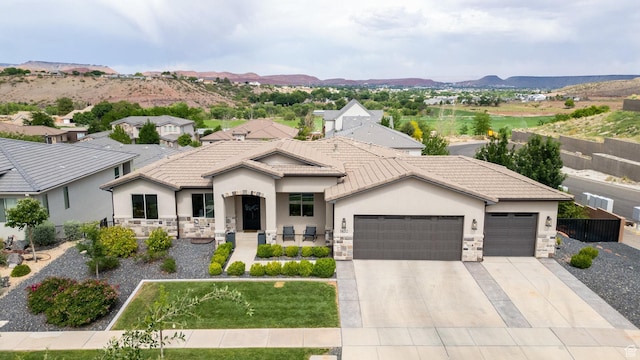 1432 Boys Pond Cir, Santa Clara, UT 84765 - view of front of house featuring an attached garage, stone siding, stucco siding, concrete driveway, and a mountain view