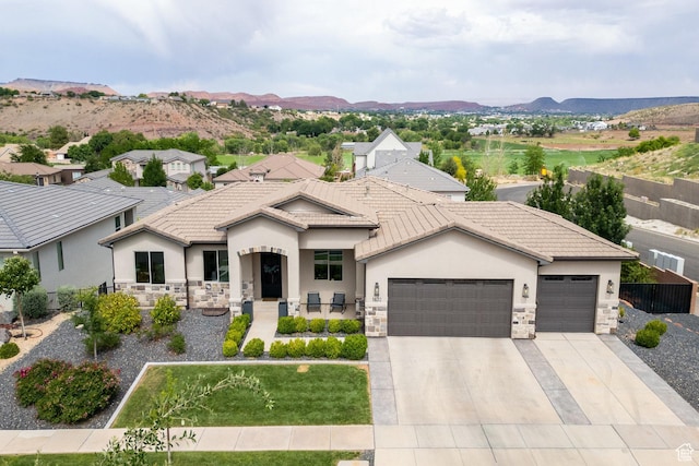 1432 Boys Pond Cir, Santa Clara, UT 84765 - view of front of home with stone siding, an attached garage, stucco siding, and concrete driveway