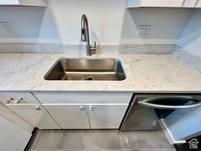 4969 S Eastridge Ln E Unit 174, Salt Lake City, UT 84117 - kitchen view of a sink, light stone counters, and white cabinets