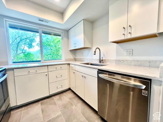 4969 S Eastridge Ln E Unit 174, Salt Lake City, UT 84117 - kitchen with dishwasher, a sink, white cabinets, and light tile patterned floors