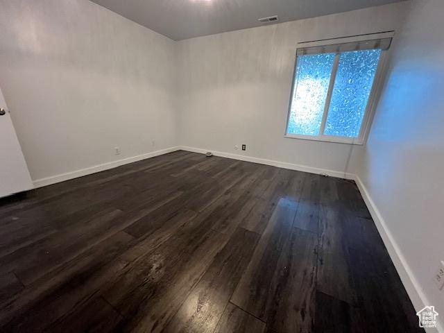 4969 S Eastridge Ln E Unit 174, Salt Lake City, UT 84117 - unfurnished room featuring dark wood-style flooring and baseboards