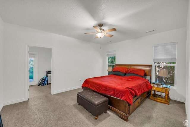 1165 W Indian Hills Dr Unit 236, St George, UT 84770 - bedroom with carpet, a textured ceiling, baseboards, and a ceiling fan
