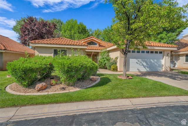 1165 W Indian Hills Dr Unit 236, St George, UT 84770 - mediterranean / spanish-style house featuring stucco siding, an attached garage, concrete driveway, a front lawn, and a tile roof