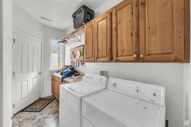 1165 W Indian Hills Dr Unit 236, St George, UT 84770 - laundry area with washer and dryer, cabinet space, and a textured ceiling