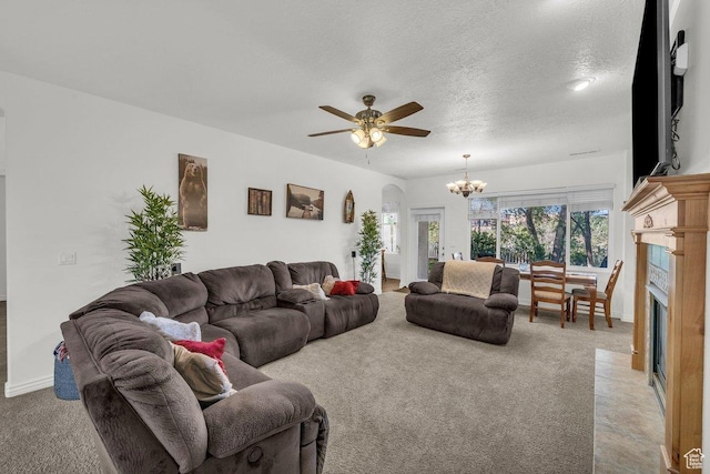 1165 W Indian Hills Dr Unit 236, St George, UT 84770 - living room featuring a chandelier, ceiling fan, light colored carpet, a fireplace with flush hearth, and a textured ceiling