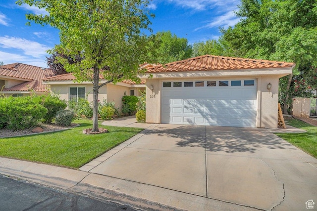 1165 W Indian Hills Dr Unit 236, St George, UT 84770 - mediterranean / spanish house with stucco siding, a tile roof, a front lawn, and an attached garage