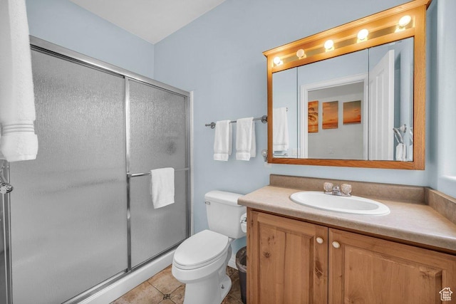 1165 W Indian Hills Dr Unit 236, St George, UT 84770 - bathroom featuring vanity, toilet, a stall shower, and tile patterned floors