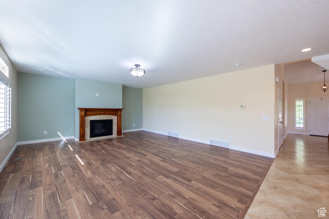 407 E Clay Ln, Lehi, UT 84043 - unfurnished living room featuring wood finished floors, a tile fireplace, and baseboards