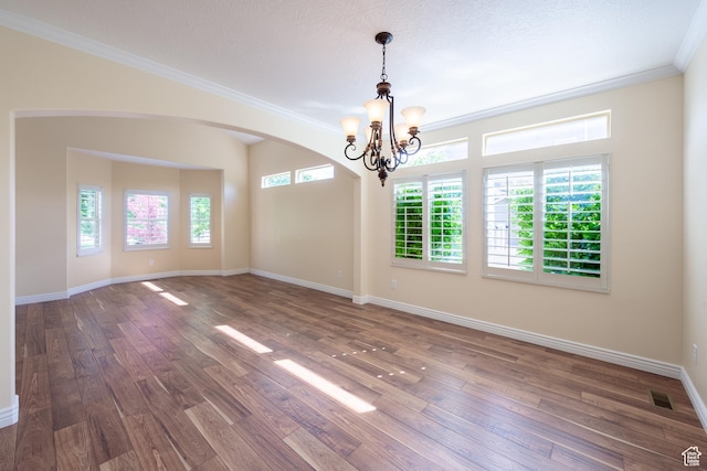 407 E Clay Ln, Lehi, UT 84043 - unfurnished room with a chandelier, crown molding, wood finished floors, arched walkways, and baseboards