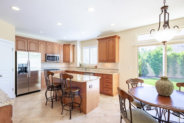 407 E Clay Ln, Lehi, UT 84043 - kitchen featuring stainless steel appliances, a kitchen island, recessed lighting, a breakfast bar, and a sink