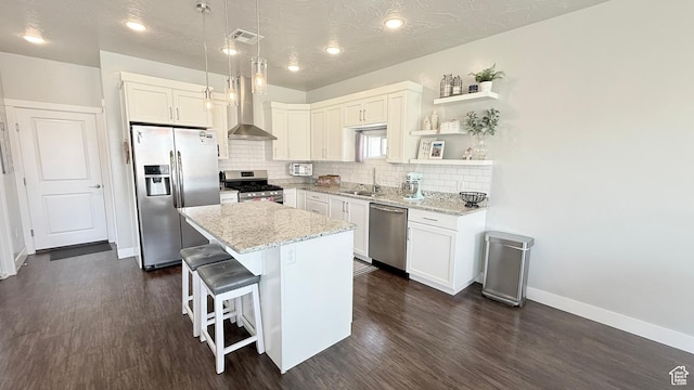 5893 S Kastra Ln, St George, UT 84790 - kitchen with stainless steel appliances, dark wood-type flooring, wall chimney exhaust hood, decorative backsplash, and a sink