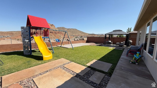 5893 S Kastra Ln, St George, UT 84790 - view of yard featuring a gazebo, a mountain view, a patio, and a playground