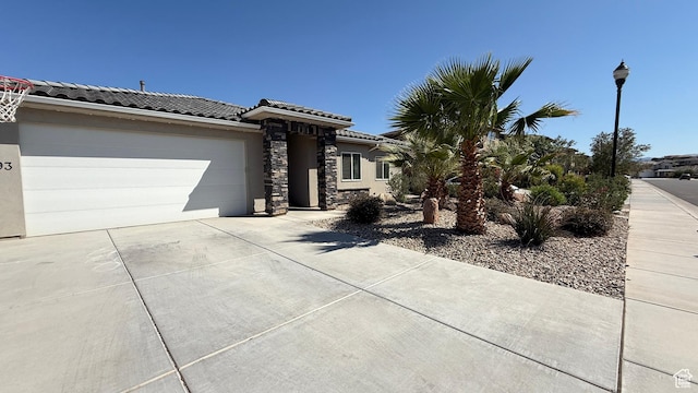 5893 S Kastra Ln, St George, UT 84790 - view of front of home with concrete driveway, a garage, a tiled roof, and stucco siding