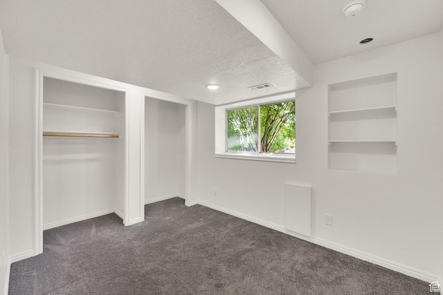 1261 E Hillsden Rd N, Layton, UT 84040 - unfurnished bedroom featuring dark carpet, baseboards, and a textured ceiling