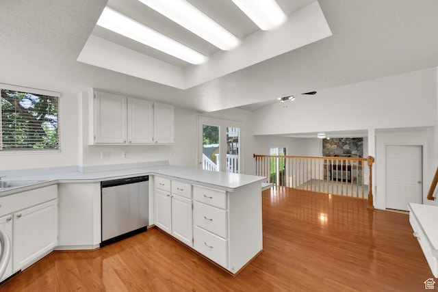 1261 E Hillsden Rd N, Layton, UT 84040 - kitchen featuring stainless steel dishwasher, a peninsula, light countertops, and light wood finished floors