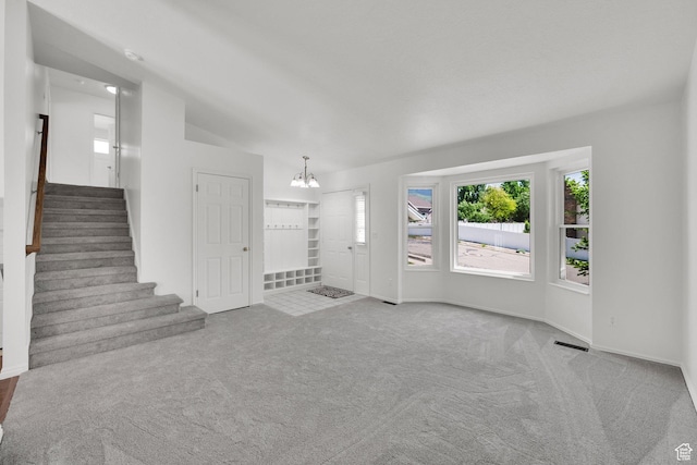 1261 E Hillsden Rd N, Layton, UT 84040 - unfurnished living room featuring carpet flooring, a chandelier, stairs, and baseboards