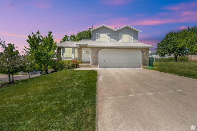1261 E Hillsden Rd N, Layton, UT 84040 - view of front of home with a lawn, an attached garage, stone siding, and driveway