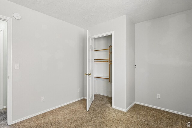 324 W 1650 N, Cedar City, UT 84721 - unfurnished bedroom with carpet flooring, a spacious closet, baseboards, a textured ceiling, and a closet