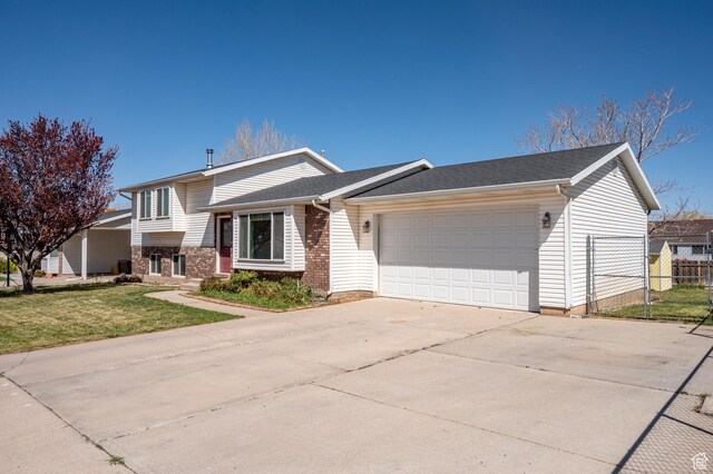 324 W 1650 N, Cedar City, UT 84721 - tri-level home with a garage, brick siding, and concrete driveway