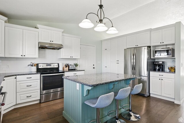 324 W 1650 N, Cedar City, UT 84721 - kitchen with appliances with stainless steel finishes, under cabinet range hood, dark wood-type flooring, dark stone counters, and white cabinetry