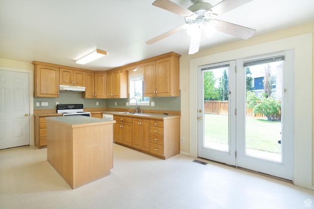 557 N 1160 E, Orem, UT 84097 - kitchen featuring a sink, white electric stove, under cabinet range hood, light countertops, and a center island
