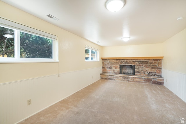 557 N 1160 E, Orem, UT 84097 - unfurnished living room featuring a stone fireplace, wainscoting, and carpet