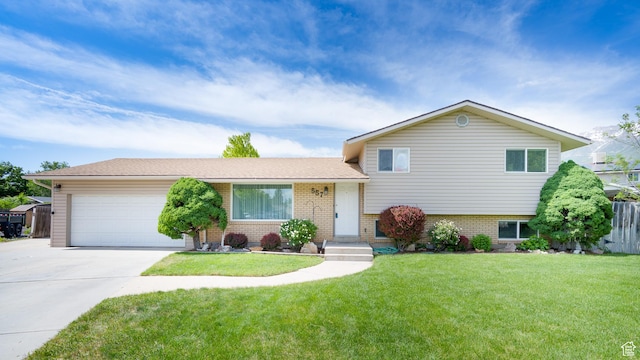 557 N 1160 E, Orem, UT 84097 - tri-level home with driveway, brick siding, and an attached garage