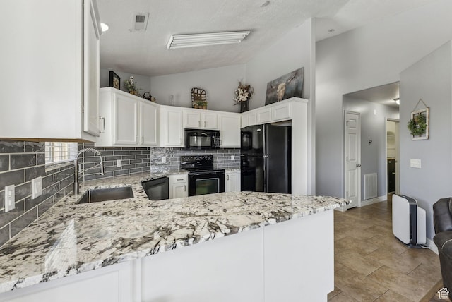 56 E Resaca Dr Unit A-12, Sandy, UT 84070 - kitchen featuring black appliances, a sink, tasteful backsplash, vaulted ceiling, and light stone counters