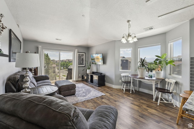 56 E Resaca Dr Unit A-12, Sandy, UT 84070 - living area featuring a chandelier, wood finished floors, plenty of natural light, baseboards, and a textured ceiling