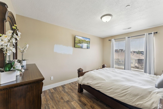 56 E Resaca Dr Unit A-12, Sandy, UT 84070 - bedroom featuring dark wood-type flooring, baseboards, and a textured ceiling