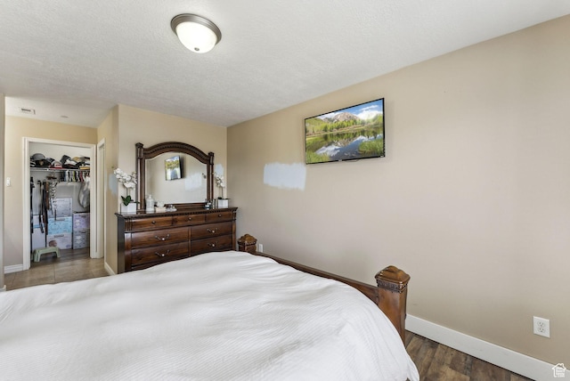 56 E Resaca Dr Unit A-12, Sandy, UT 84070 - bedroom featuring baseboards, wood finished floors, a textured ceiling, and a closet