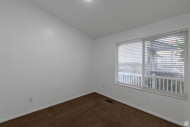 3388 W Briar Dr S, West Jordan, UT 84084 - empty room featuring dark carpet, baseboards, and vaulted ceiling
