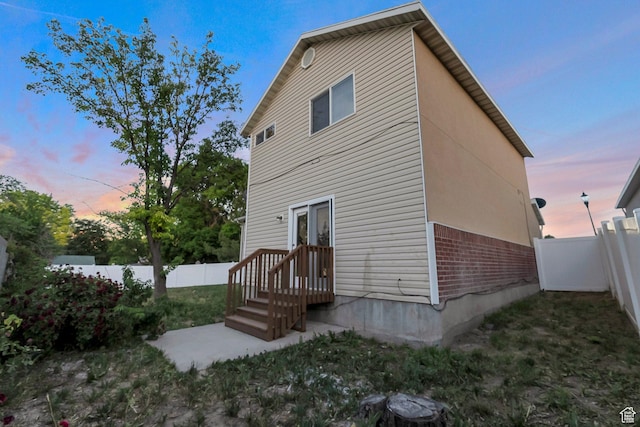 3388 W Briar Dr S, West Jordan, UT 84084 - back of property at dusk with brick siding and a fenced backyard
