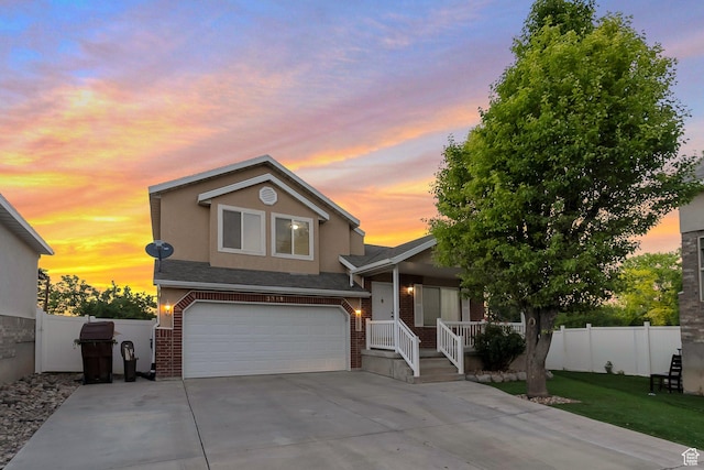 3388 W Briar Dr S, West Jordan, UT 84084 - view of front facade featuring an attached garage, brick siding, concrete driveway, and stucco siding