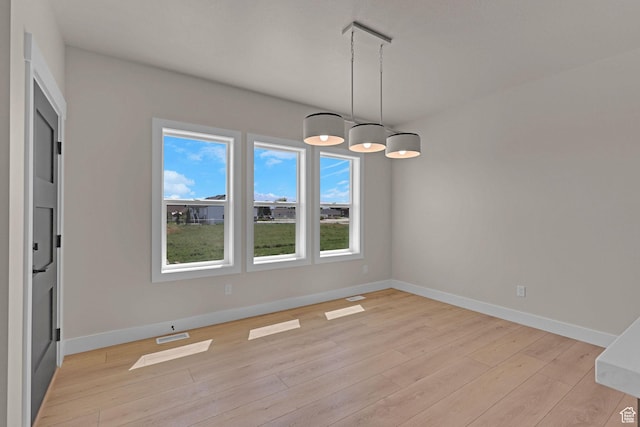 4594 S 6300 W, Hooper, UT 84315 - unfurnished dining area with light wood-type flooring and baseboards