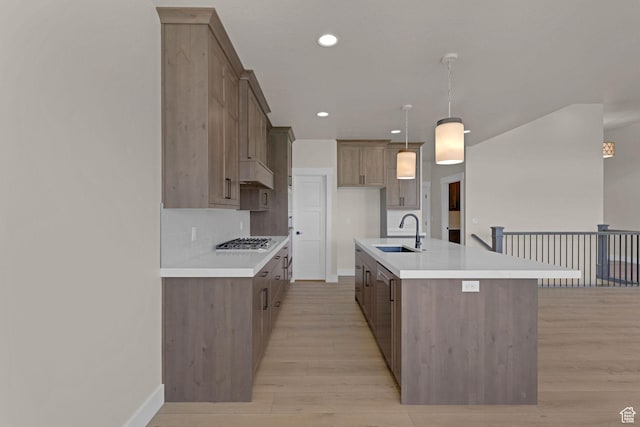 4594 S 6300 W, Hooper, UT 84315 - kitchen with a sink, gas cooktop, light wood-style floors, baseboards, and recessed lighting
