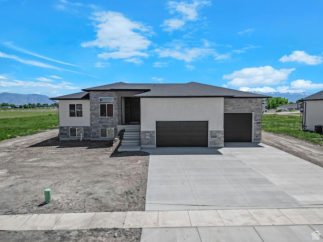 4594 S 6300 W, Hooper, UT 84315 - prairie-style home featuring stone siding, a garage, a mountain view, and concrete driveway