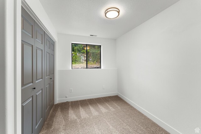 4077 N Devonshire Cir, Provo, UT 84604 - unfurnished bedroom with carpet floors, a closet, baseboards, and a textured ceiling