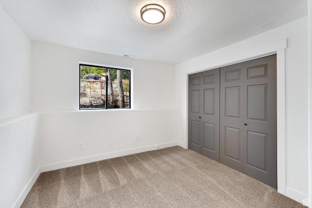 4077 N Devonshire Cir, Provo, UT 84604 - unfurnished bedroom featuring carpet flooring, a textured ceiling, baseboards, and a closet